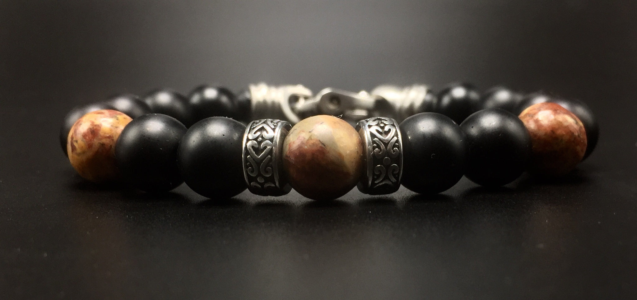 10mm matte black onyx beads, 10mm picture jasper beads ,  and stainless steal  rondelles. 