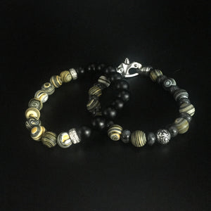 Yellow Malachite and gray Labradorite with a sterling silver center filagree bead and stainless steel clasp.