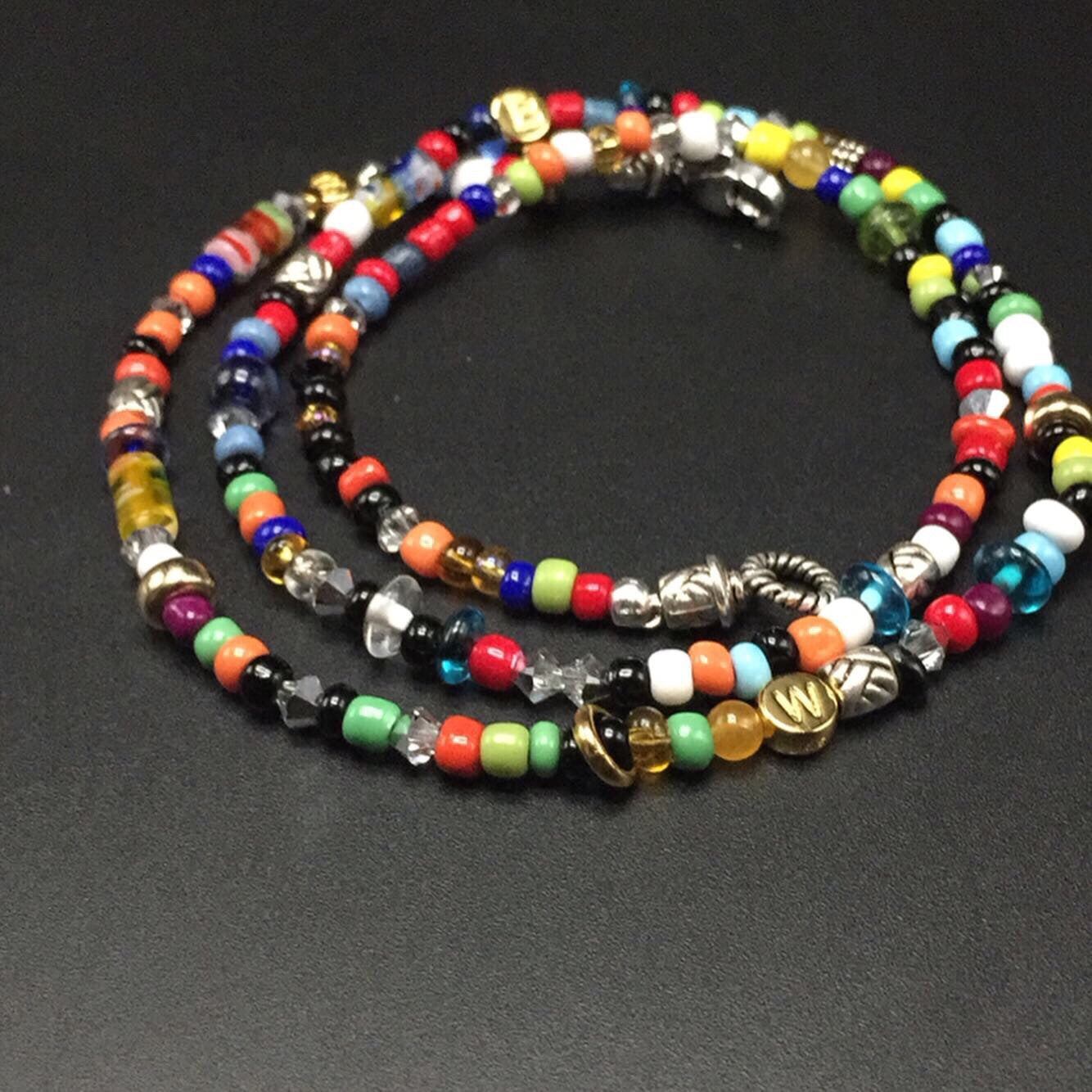 14 karat gold, sterling silver and Swarovski crystals with a playful mix of colored seed beads.
