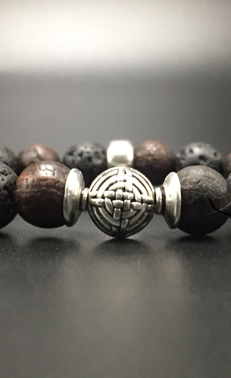 sterling silver center bead with volcanic lava and fossilize stone.
